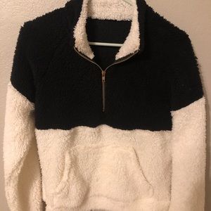 Black and white quarter zip. Fits like a small.
